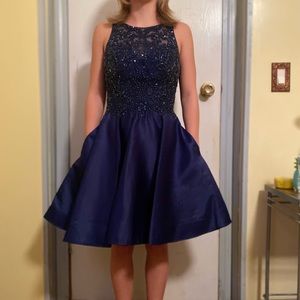 a short, blue, beaded topped dress with pockets